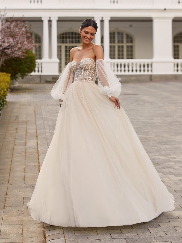 Pronovias 2022 Bridal Collection features a corset bodice, lots of textured beading, and the wedding dress trend of 2023-- detachable sleeves.