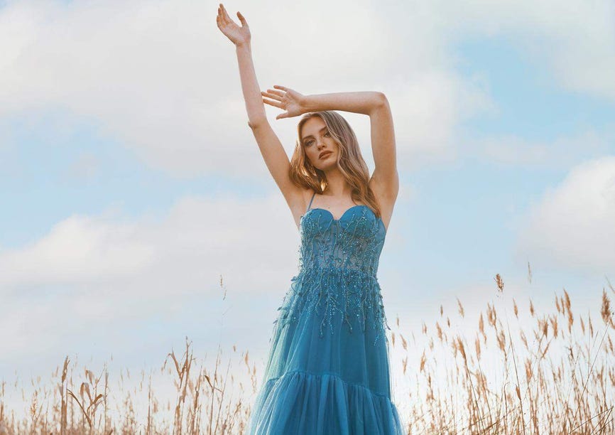 Une femme élégante revêt une robe d'anniversaire de mariage bleue sans bretelles, ornée de perles délicates