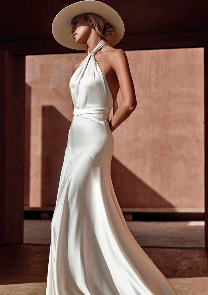 Blonde woman in a halter wedding gown with hat