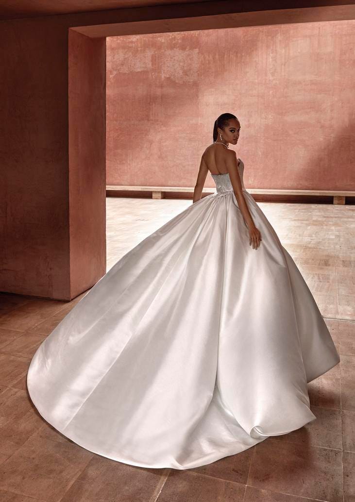 Woman in a strapless ball gown wedding dress in silk.