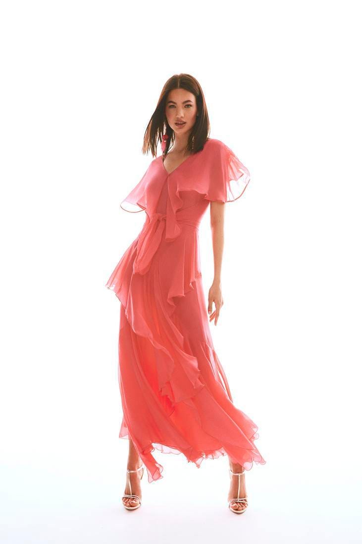 Mujer con un vestido de fiesta rosa con volantes para protocolo de boda de tarde