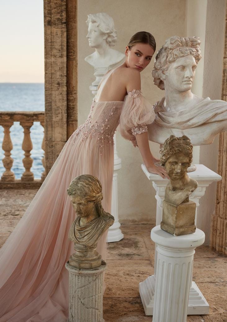 Woman in a pink low back wedding dress with puffy sleeves